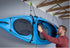 Kayak hoisted effortlessly using Tie Boss pulley system in a garage.